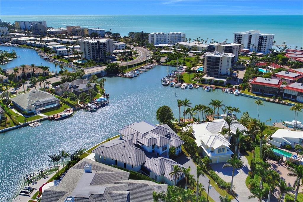 Aerial view of The Moorings bay and beach, single family homes, condominiums